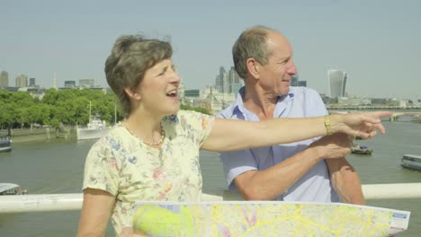 Active-senior-couple-looking-at-a-map-in-london