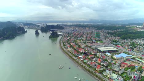 4k-Aerial-view-over-city-and-park-with-Bai-Tho-karst-mountain-Ha-long-bay.-Halong-City.