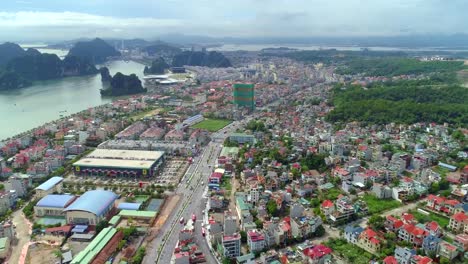 4k-Aerial-view-over-city-and-park-with-Bai-Tho-karst-mountain-Ha-long-bay.-Halong-City.