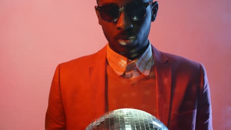 Black-Man-with-Disco-Ball-on-Pink-Background