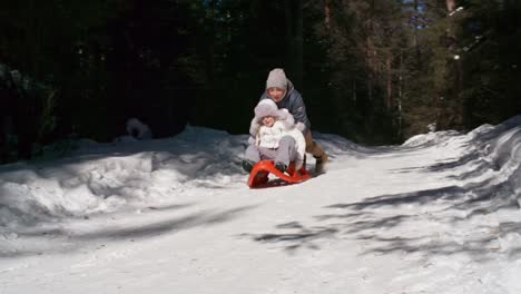 Brother-and-Sister-Having-Fun-Sledding