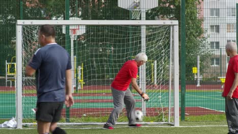 Senior-Friends-Playing-Football-Outdoors