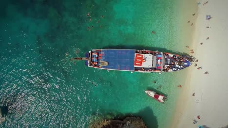 Aerial-view-of-people-disembarking-off-ferry,-Ithaki-island,-Greece.