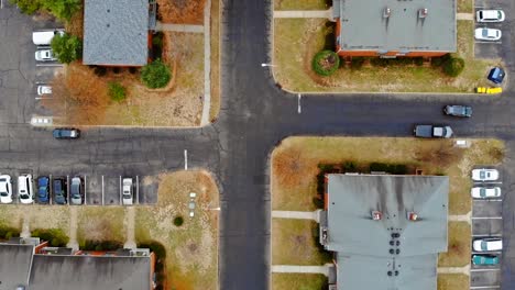 Aerial-shot-of-housing-community-streets-and-residential-buildings-in-height-view-from-above-yellow-trees-and-houses