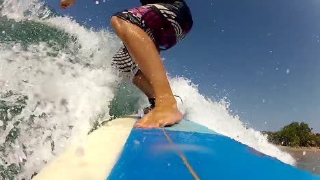 CLOSE-UP:-Young-male-surfer-catching-waves