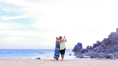 An-older-couple-dancing-on-the-beach
