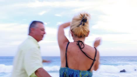 Close-up-of-an-older-couple-dancing-on-the-beach