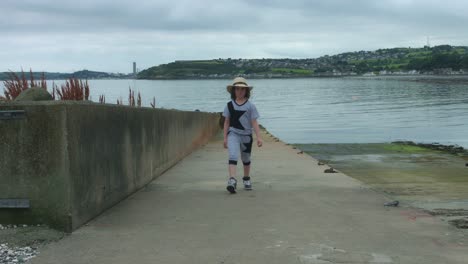 4k-Sea-View-Shot-of-a-Child-Running-on-harbour