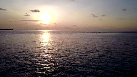 v04102-Aerial-flying-drone-view-of-Maldives-white-sandy-beach-2-people-young-couple-man-woman-paddleboard-rowing-sunset-sunrise-on-sunny-tropical-paradise-island-with-aqua-blue-sky-sea-water-ocean-4k