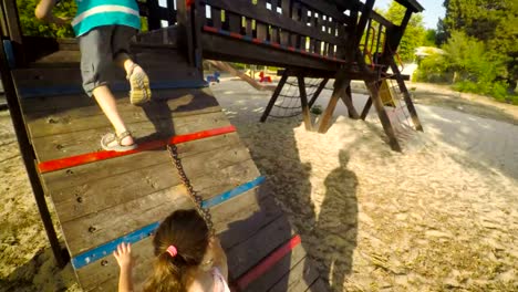 POV-footage-of-three-kids-playing-in-a-playground