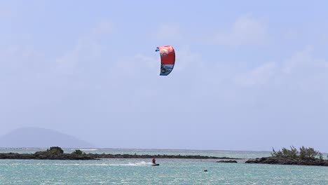 Man-kitesurfing-in-ocean,-extreme-summer-sport-in-island-Mauritius