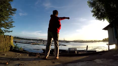 Mature-woman-Dance-Exercise-at-lake-shore.-silhouettes