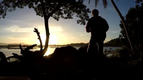 Mature-woman-Dance-Exercise-at-lake-shore.-silhouettes