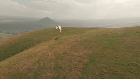 Athlete-paraglider-flies-on-his-paraglider-next-to-the-swallows.-Follow-up-shooting-from-the-drone