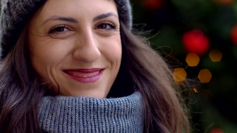 pensive-cute-brunette-thinking-and-smiling-at-camera--Christmas-Time--oudoor