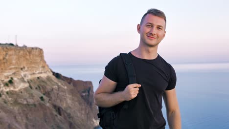 Portrait-of-athletic-friendly-European-young-man-with-backpack-on-his-shoulder