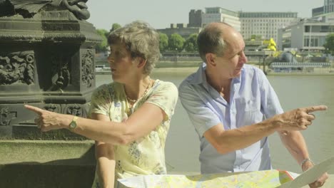 Active-senior-couple-looking-at-a-map-in-london