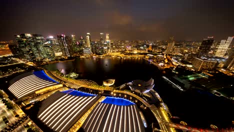 Time-lapse-of-lights-show-at-downtown-Singapore-City-in-Marina-Bay-area.-Financial-district-and-skyscraper-buildings.-Aerial-view-at-night.