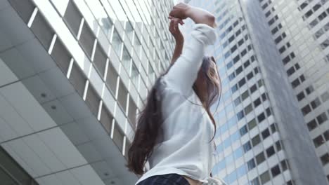 Young-Woman-Dancing-Under-Financial-District-Skyscrapers