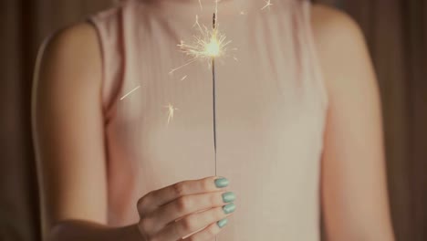 Footage-woman-holding-sparkler-and-celebrating-new-year-or-success-business
