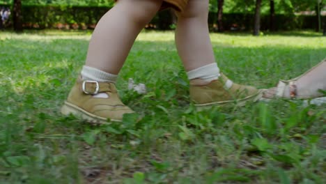 Unrecognizable-Baby-Taking-First-Steps-Outdoors