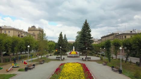 Drone-flight-over-the-city-park-and-bright-flowerbeds