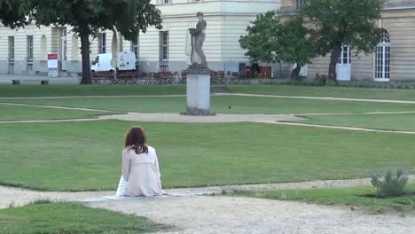 A-woman-sitting-in--park