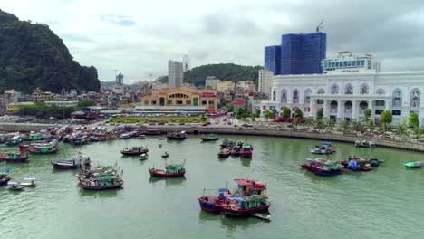 4k-Aerial-view-over-city-and-park-with-Bai-Tho-karst-mountain-Ha-long-bay.-Halong-City.