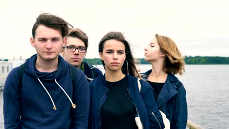 A-group-of-teenagers-standing-on-the-bridge-of-the-river.