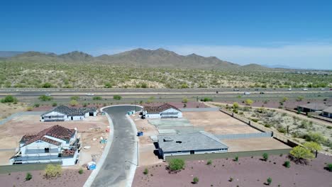 Aerial-Arizona-New-Home-Construction-Site-and-Highway-Fly-Left