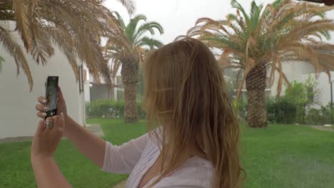 Young-woman-taking-selfie-on-rainy-day