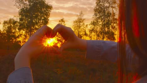 4k---Pro-Wind-PowePro-Nature---Beautiful-young-woman-forming-a-heart-shape-with-her-hands