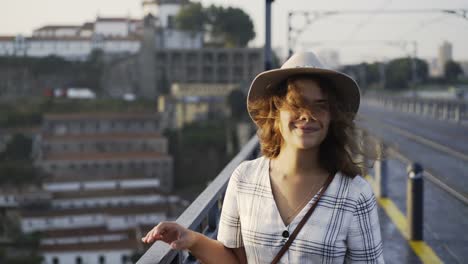 Portrait-Lady-in-hat-walking-on-bridge-at-sunrise