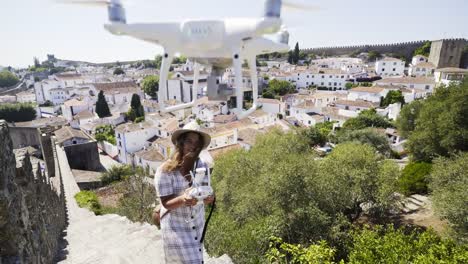 Woman-piloting-drone-in-old-town