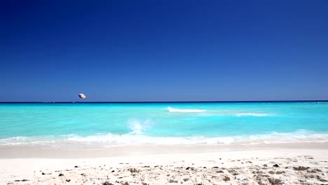 Young-man-running-in-to-the-ocean-on-beach