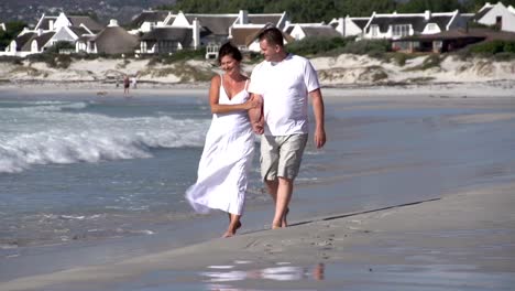 Romantic-couple-walking-along-beach,-Cape-Town,-South-Africa