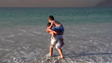 2-young-boys-playing-in-the-shallow-sea-water,-Cape-Town