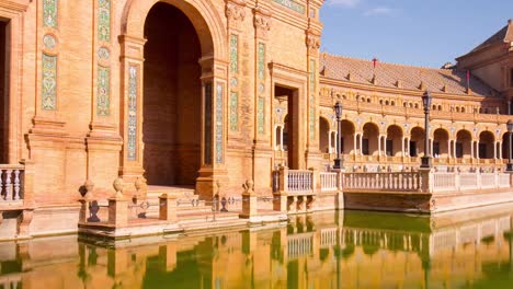 sun-light-seville-palace-of-spain-front-pond-reflection-4k-time-lapse-spain