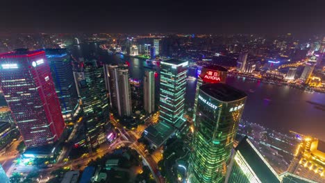 china-shanghai-cityscape-night-illumination-roof-top-arial-panorama-4k-time-lapse
