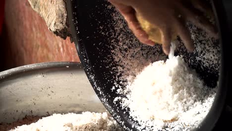 Woman-extraction-of-coconut-pulp