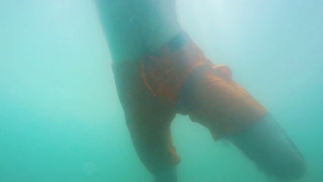 Underwater-shot-of-a-man-swimming-in-the-sea