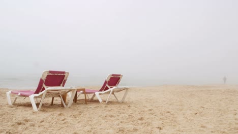 A-woman-jogs-along-the-coast-in-a-very-foggy-day,-Mediterranean-Sea,-Israel.