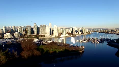 Rising-aerial-of-downtown-and-snowcapped-mountains