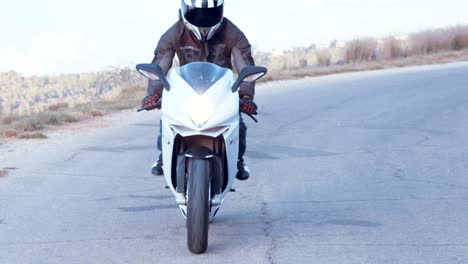 Man-riding-on-a-white-sports-motorcycle