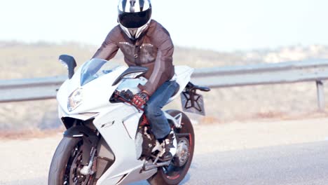 Man-riding-on-a-white-sports-motorcycle