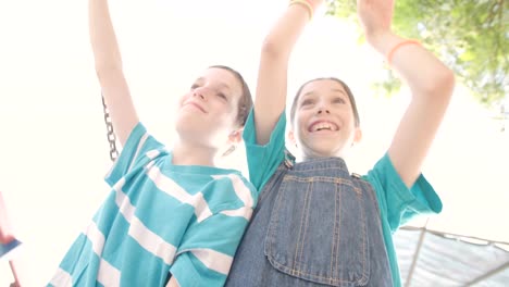 Children-swinging-together-at-a-public-playground