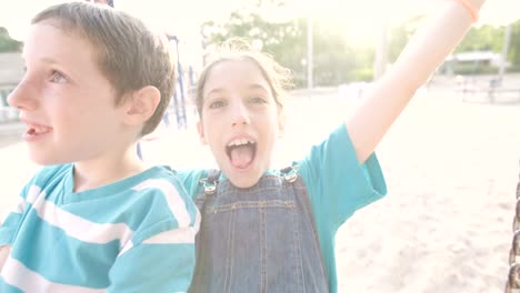 Children-swinging-together-at-a-public-playground