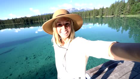 Woman-selfie-pov-by-alpine-lake-in-the-Canadians-rockies