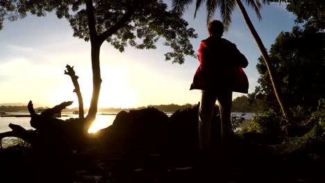 Mature-woman-Dance-Exercise-at-lake-shore.-silhouettes