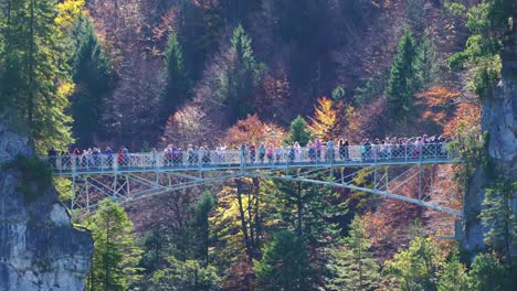 Tourists-stand-on-Marienbruecke-(Marie's-Bridge),-Bavaria,-Germany